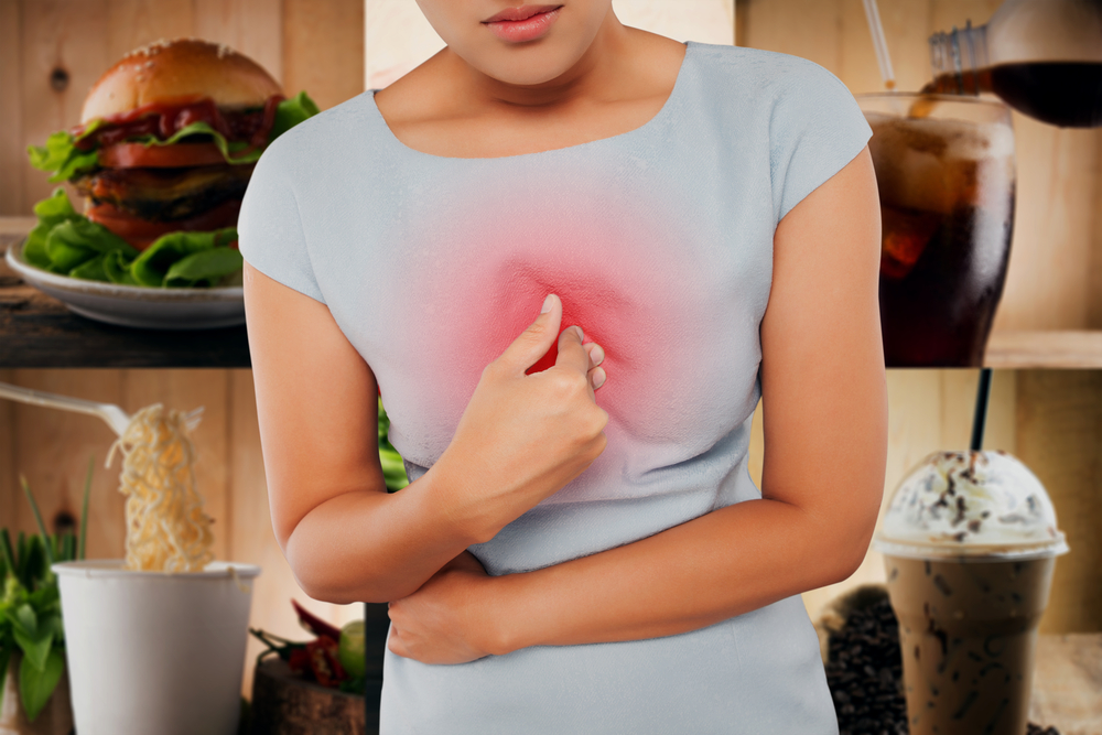 Woman,With,Symptomatic,Acid,Reflux,,On,Food,Background