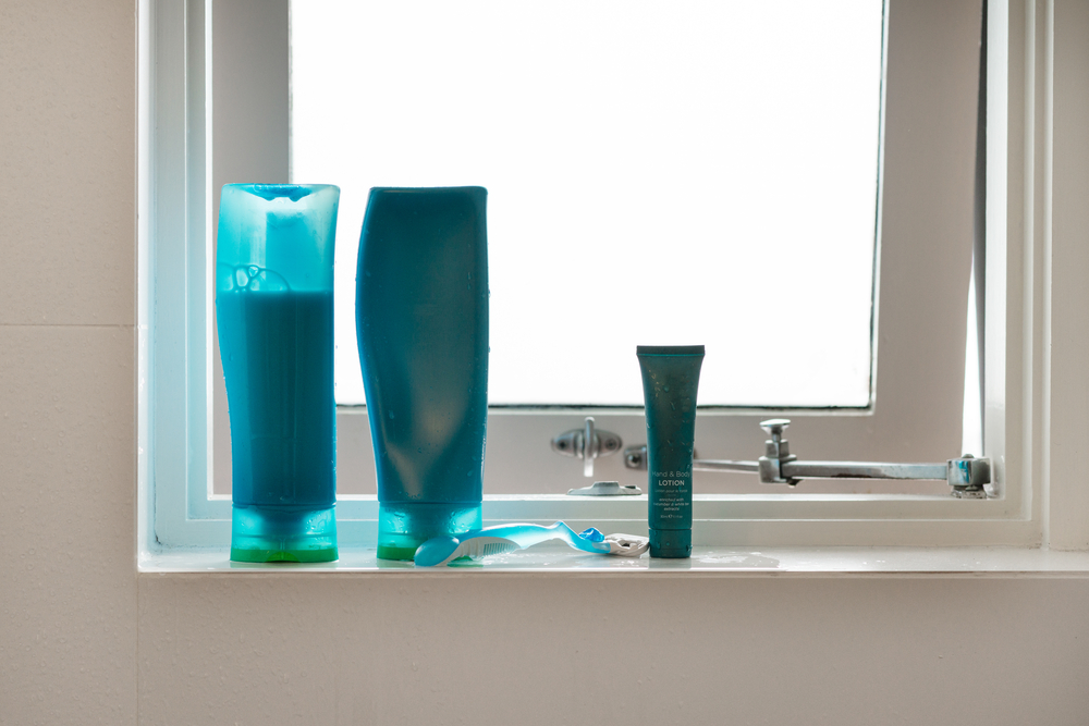 Blue,Shampoo,And,Conditioner,Bottles,On,Bathroom,Window,Ledge
